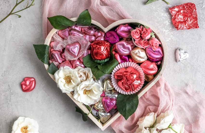 Madelaine foil wrapped chocolate hearts, lips and roses in a heart box